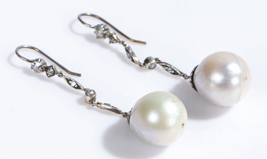 Pair of diamond and pearl set earrings, with diamonds set to the stem above the drop pearl, 50mm