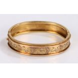 Victorian yellow metal bangle, with a foliate design to the channel moulded body, 15.5 grams