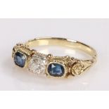 Sapphire and diamond set ring, the central diamond at 0.23 carat flanked by sapphires at 0.67