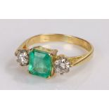Emerald and diamond set ring, with a central emerald at 1.48 carat and a diamond to either side at