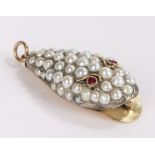 Pearl and ruby set snake head pendant, of large proportions, the open mouthed head set with pearls