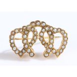 Victorian pearl set brooch, in the form of three inter woven horseshoes, 27mm diameter