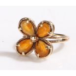 9 carat gold ring, with four orange stones set in a flower head formation, ring size J1/2, 4g