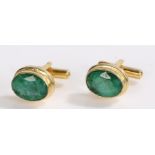 Pair of emerald and gilt metal cufflinks, with oval set heads