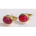 Pair of ruby and gilt metal cufflinks, with oval set heads