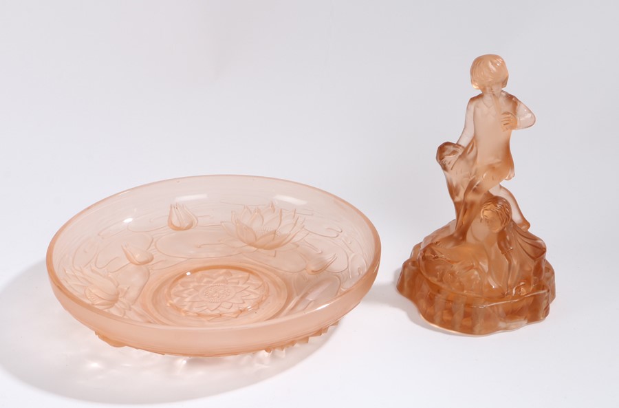 Puce glass table centerpiece, the centre modelled as two children surrounded by rabbits, above a