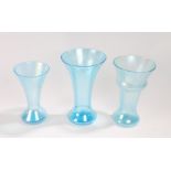 Three John Walsh Walsh Glass blue glass vases, all with ridged tapering bodies, the largest