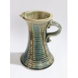 Studio pottery jug, with ridged tapering body and loop handle, initialled MJ to base, 26cm high