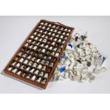 Collection of porcelain thimbles, housed in a hanging wall shelf, loose thimbles (qty)