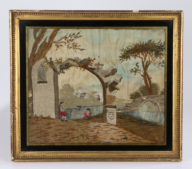 George III silk work picture, depicting primitive figures under an arch by a river, 42cm x 36cm