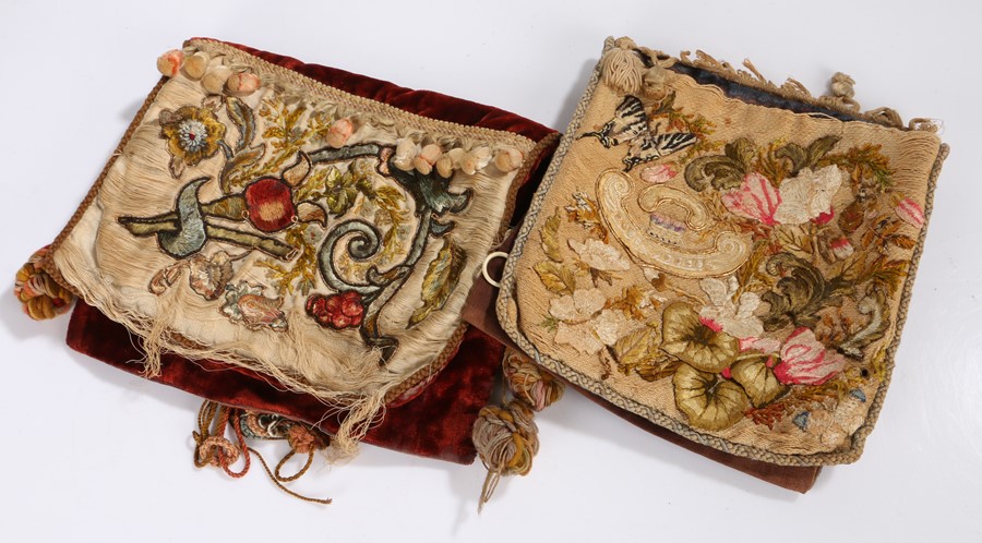 Two 19th Century crewel work decorated bags, the red and blue velvet bags with foliate embroidered