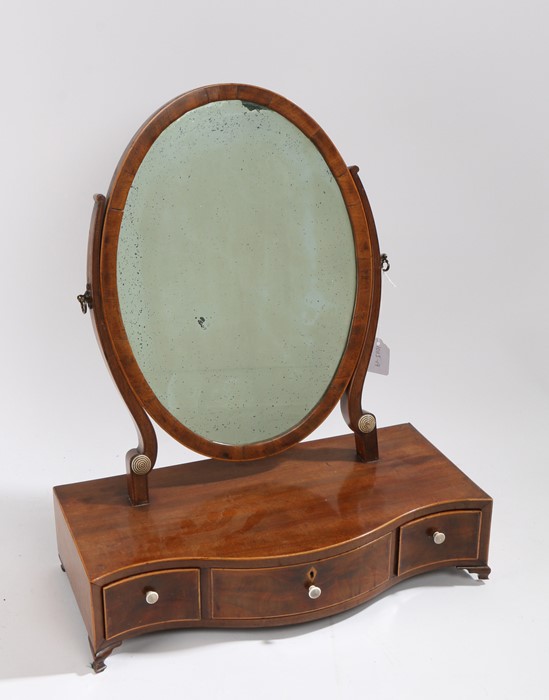 Regency mahogany and boxwood strung toilet mirror, the oval mirror plate above a serpentine base