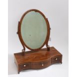 Regency mahogany and boxwood strung toilet mirror, the oval mirror plate above a serpentine base