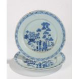 Pair of 18th Century Delft plates, with a large flower and tall trees to the centre, hatched cross