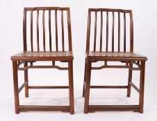 Pair of Chinese hardwood chairs, possibly hongmu wood, Qing Dynasty, the stepped top rail above a