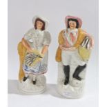 Pair of Staffordshire figures in the form of a fisherman and lady, each 34cm high, (2)