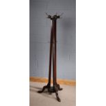 Edwardian mahogany coat stand, the top with five hooks, above three fluted supports with hooks,
