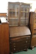 Oak bureau bookcase, with two lead glazed doors above the fall, three long drawers to the base, 76cm