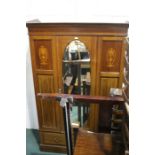 Edwardian mahogany and marquetry inlaid wardrobe,the dentil inlaid pediment above an oval bevelled