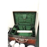 Brown leather vanity case, the hinged lid opening to reveal a green watered silk interior with