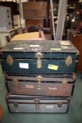 Three 20th Century metal bound trunks, with leather handles and travel labels, 90cm wide (3)