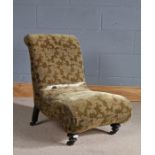 Victorian nursing chair, with a curled back and seat above ebonised turned legs and rear legs