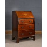 Edwardian mahogany and inlaid bureau, of small proportions, the rectangular top above an urn