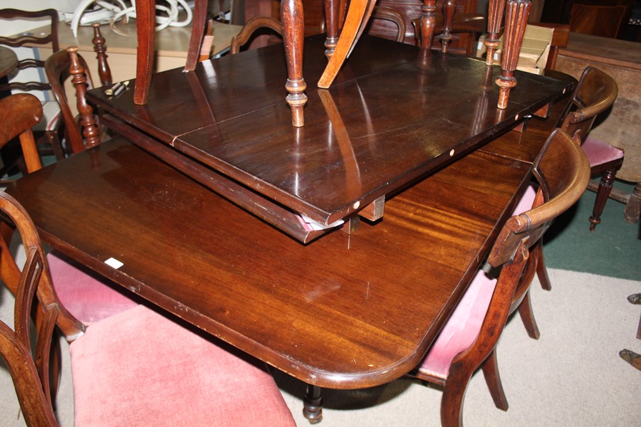 Regency style mahogany dining table, raised on two turned columns, tripod legs and pad feet, with