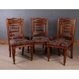 Set of six Edwardian mahogany dining chairs, with a carved top rail and spindle back above a stuff