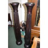 Pair of ebonised wooden candlesticks, with reeded stems, 120cm high