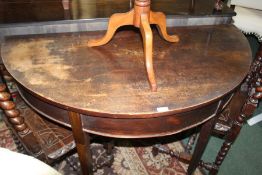 19th Century mahogany demi lune table, above square section legs and spade feet