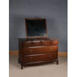 Stag dressing table, with mirror above three short and two long drawers, 106cm wide