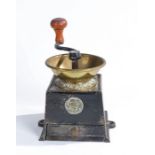 A 19th century cast iron and gilt pressed copper coffee grinder, by Archibald Kenrick and Sons