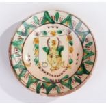 Colilola pottery dish, with green and yellow glazes, centred with an animal, impressed mark to