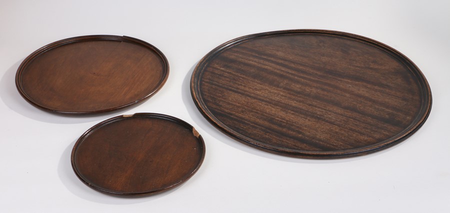 19th Century mahogany circular tray, 45cm diameter, together with two other circular trays