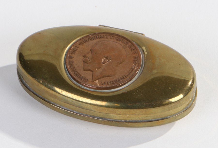 Miners brass twist tobacco box, of oval form, the hinged lid inset with a George V penny, 7.5cm