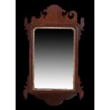 19th Century mahogany wall mirror, the rectangular mirror plate held within a shaped frame and
