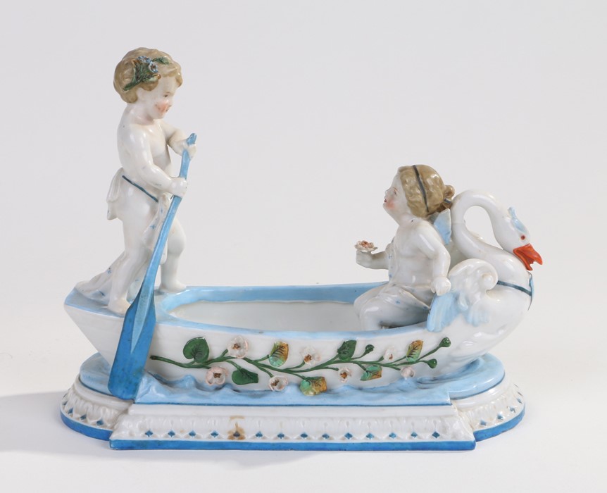 KPM Berlin porcelain table centre piece, in the form of two cherubs in a boat, blue stamp mark to