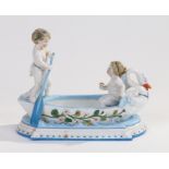 KPM Berlin porcelain table centre piece, in the form of two cherubs in a boat, blue stamp mark to