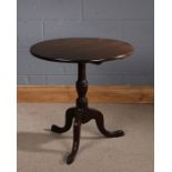 George III mahogany occasional table, the circular top above a turned column, raised on three