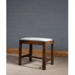 George III mahogany dressing stool, having drop in seat and raised on square chamfered legs united