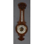 Early 20th Century golden oak cased aneroid barometer/ thermometer, the white dial with retailers