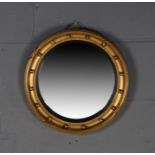 Regency style convex wall mirror, with gilt ball and ebonised surround, 40cm diameter