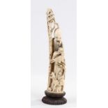 Japanese carved ivory immortal, Meiji period, wearing a flowing robe and holding a staff, raised