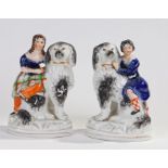 Pair of Victorian Staffordshire figures, modelled as seated dogs and figures, 17.5cm high (2)