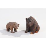 Two Black Forest carved wooden bears, one modelled in a seated position (AF), (2)