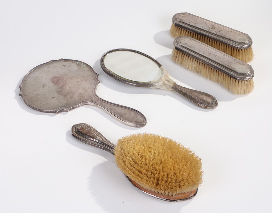 George V silver hand mirror, Birmingham 1927, together with a pair of similar brushes, London