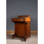 Edwardian walnut Davenport, the rectangular top with a mounted stationary box, besides the writing