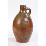 18th Century stoneware bottle, in the form of a Bellarmine, the rounded neck above a baluster