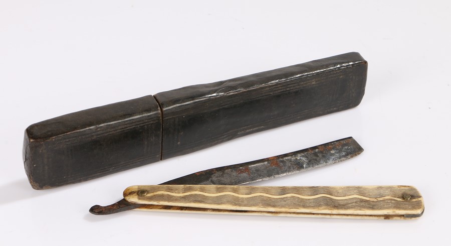 Early 19th Century cut throat razor, the leather clad case enclosing the bone etched handle and